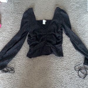 Brand:H&M size:xs long sleeve shirt with string on the ends of the sleeves